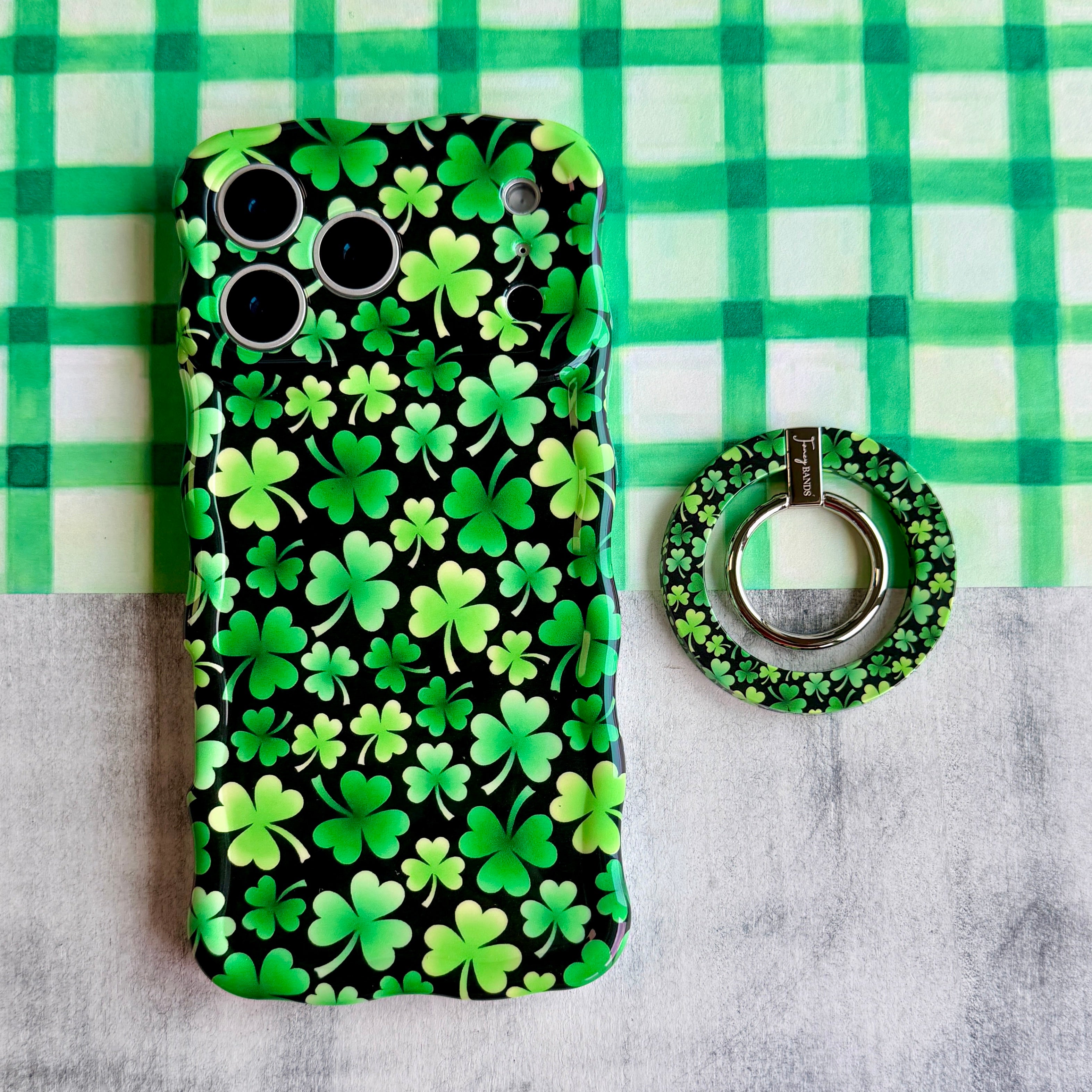 Shamrock pattern MagSafe phone grip ring with green clovers on a black background compatible with iPhone and Samsung