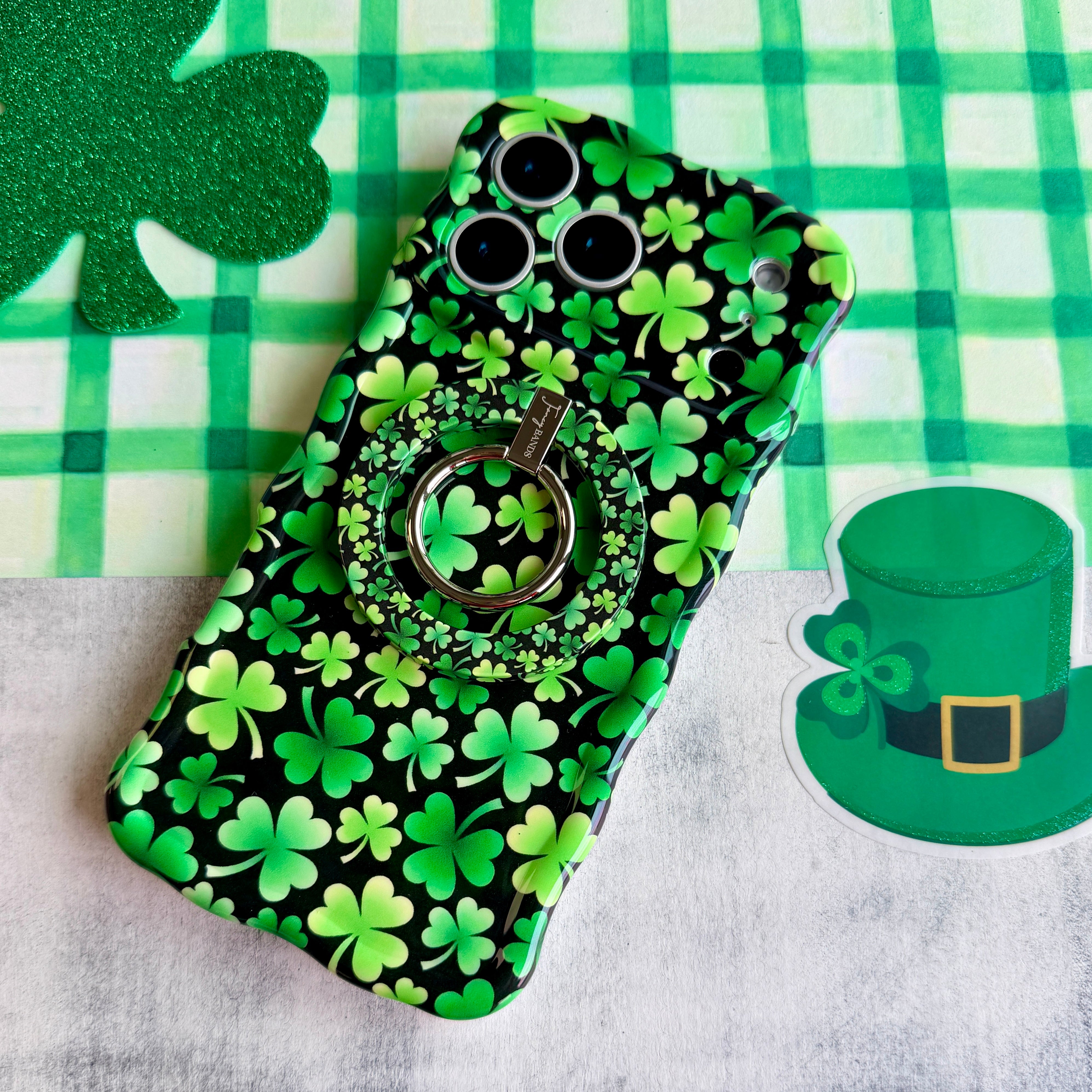Shamrock pattern MagSafe phone grip ring with green clovers on a black background compatible with iPhone and Samsung