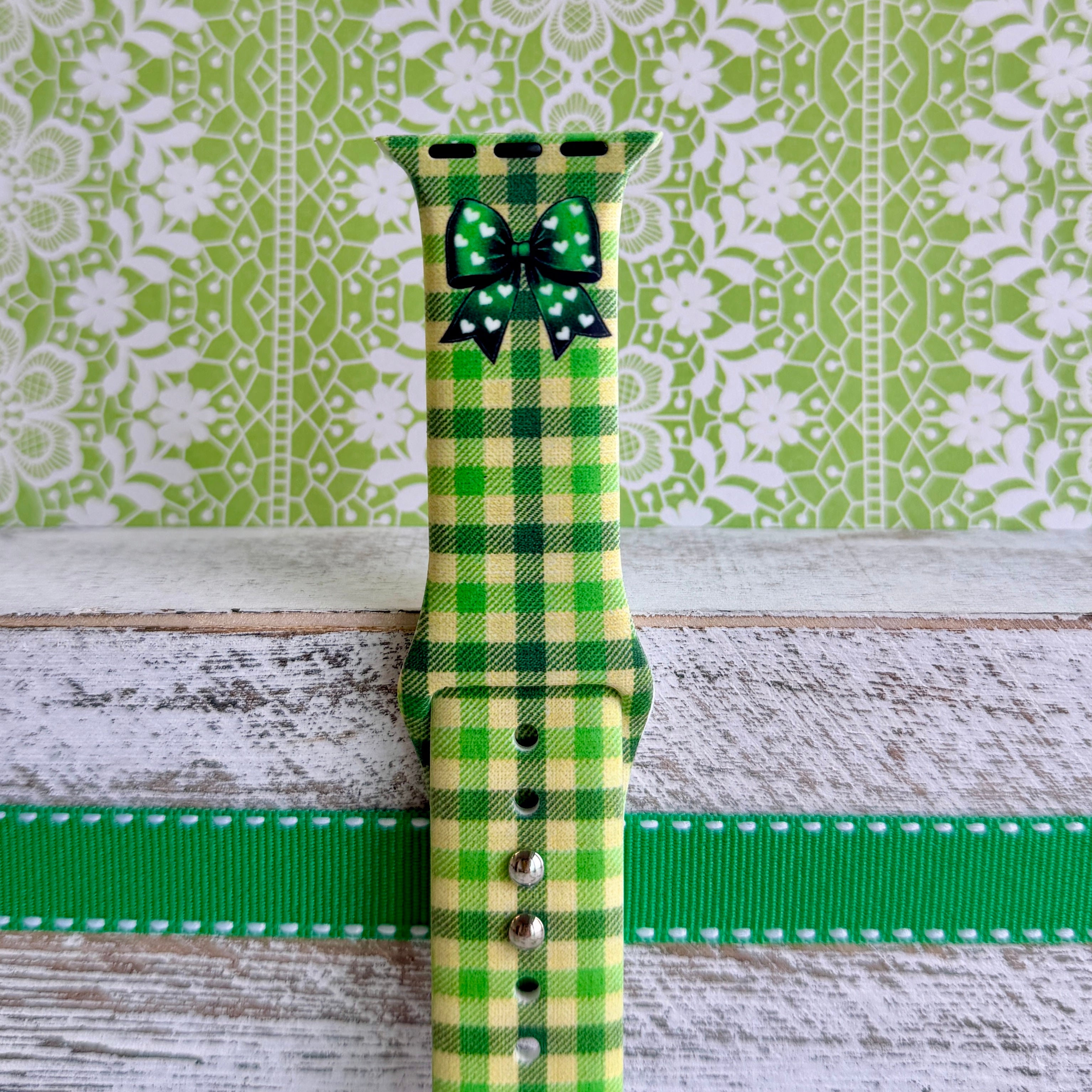 Green gingham Apple Watch band with bow detail on silicone strap