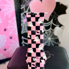 Close view of the Hey Boo, Looking Cute Apple Watch band showing the white ghosts and small black bats across the pink and black checkerboard.