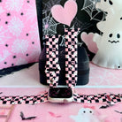 Hey Boo, Looking Cute silicone Apple Watch band standing upright with an Apple Watch at its base, pink and black checkerboard with white ghosts.