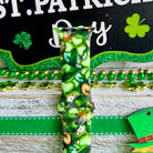 St. Patrick's Day Apple Watch band with green shamrocks, gold coins, and leprechaun hats on festive display

