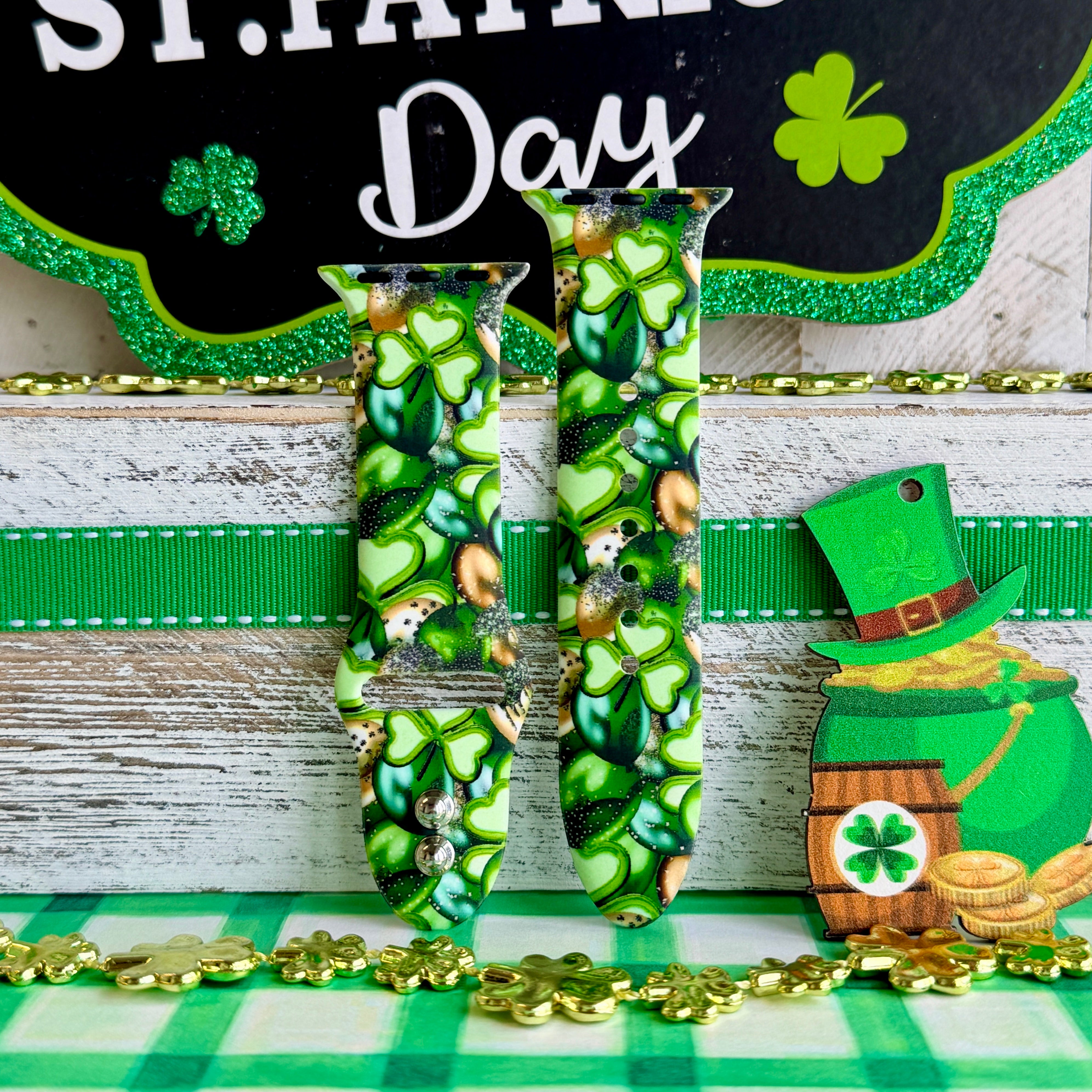 St. Patrick's Day Apple Watch band with green shamrocks, gold coins, and leprechaun hats on festive display
