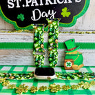 St. Patrick's Day Apple Watch band with green shamrocks, gold coins, and leprechaun hats on festive display
