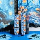 Both sizes of The Bewitching Hour Apple Watch band standing side by side against a moonlit blue Halloween forest backdrop.