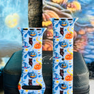 Close view of The Bewitching Hour Apple Watch band, light blue silicone printed with orange and blue jack-o-lanterns, blue witch hats, owls, yellow stars and moons.