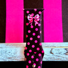 Sweet Spot Apple Watch band with pink polka dots and bow accents on black background with striped backdrop
