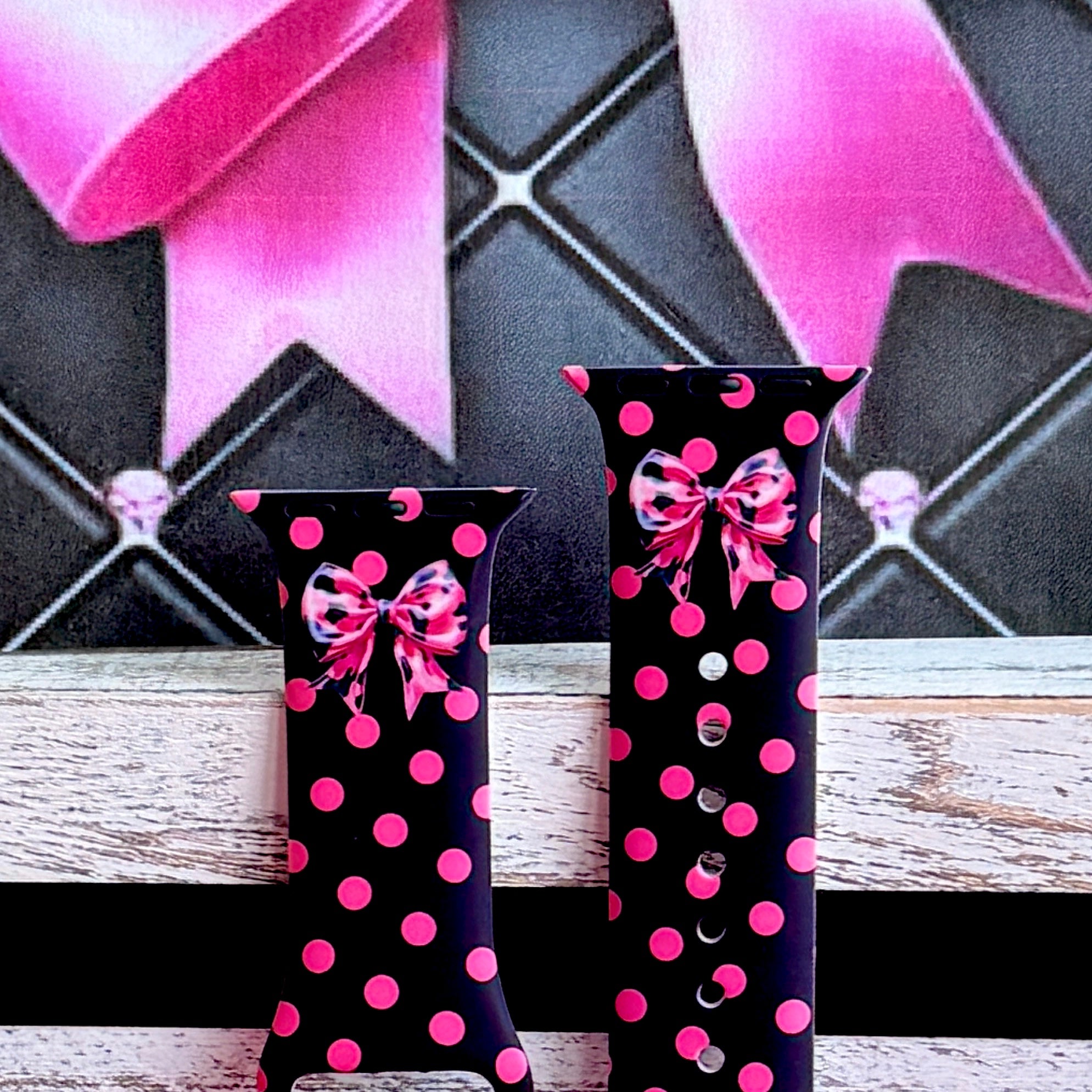 Sweet Spot Apple Watch band with pink polka dots and bow accents on black background with striped backdrop
