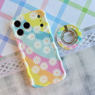 Daisy Dream MagSafe grip ring with pastel rainbow waves and white daisies on phone