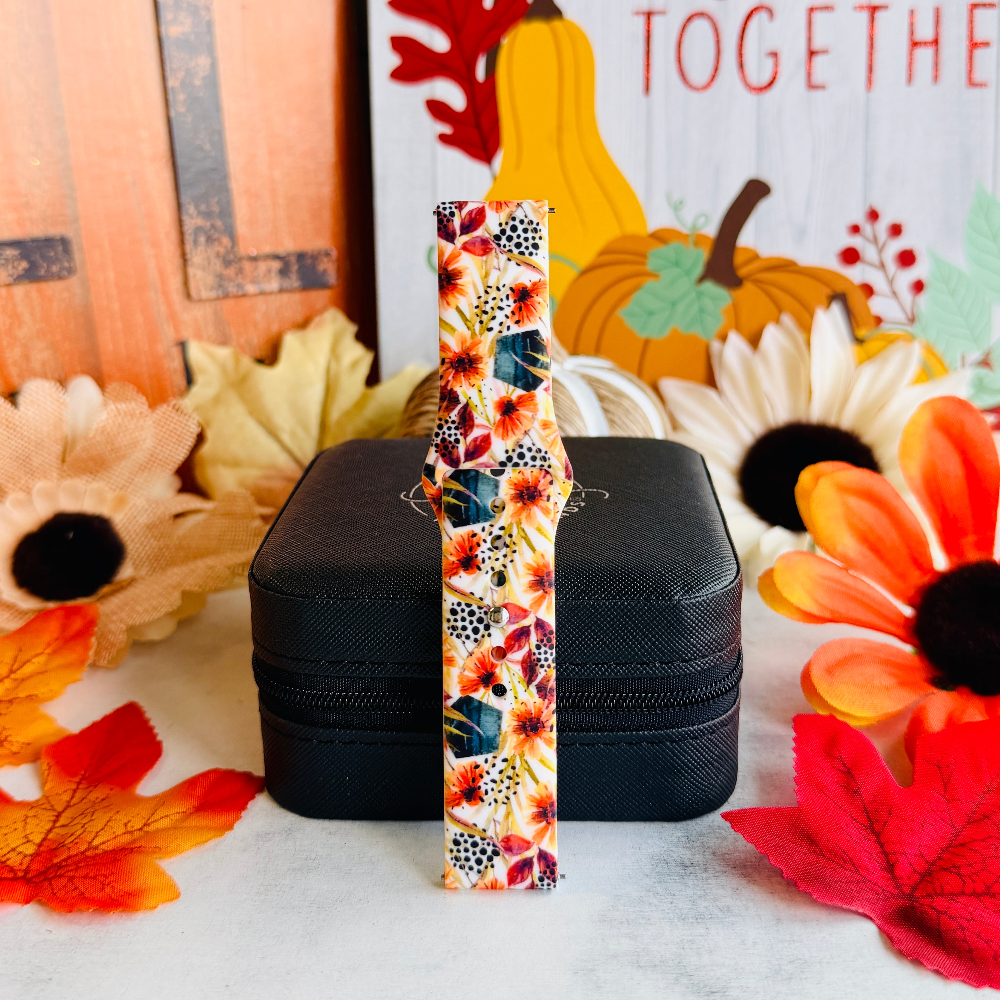 Sienna Petals Samsung Galaxy Watch band standing full length in front of a Gather Together fall sign with pumpkins and sunflowers.