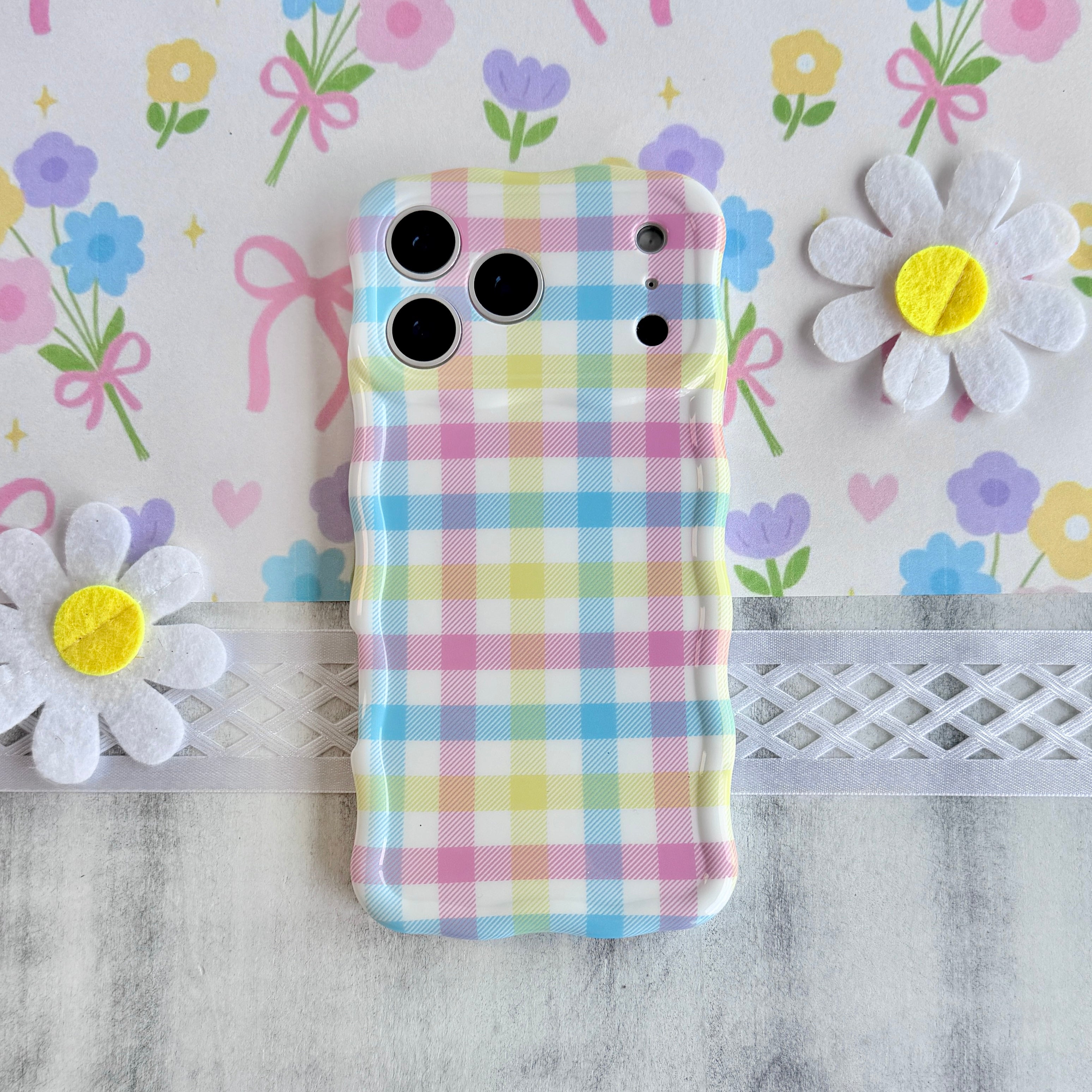 Wavy iPhone case featuring a multi-colored pastel gingham pattern in pink, yellow, green, and blue.