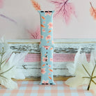 Autumn Breeze silicone Apple Watch band standing full length against a soft pink backdrop painted with maple leaves.