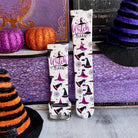 Two Witch Please Fitbit Versa 3/4 and Sense band straps standing with the buckle visible and witch hats across the cream silicone.