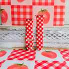Red Barn Babe Apple Watch band in both size options on a whitewashed wood ledge, red gingham print against a strawberry backdrop.