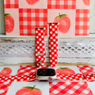 Red Barn Babe silicone Apple Watch band shown in both sizes with an Apple Watch at the base, red and white gingham cut on the bias.