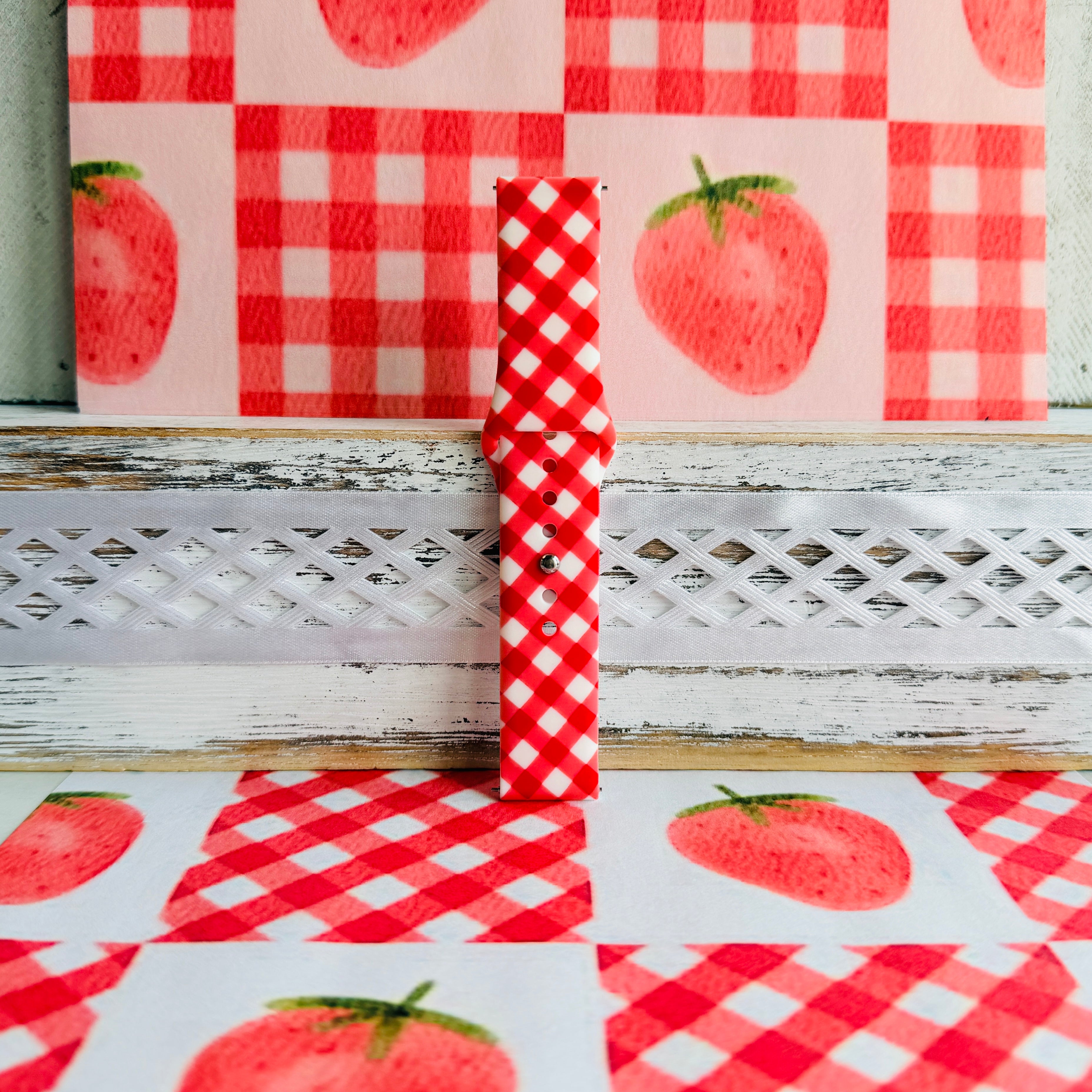 Red Barn Babe Samsung Galaxy Watch band standing full length against a red gingham and strawberry backdrop.