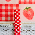 Close view of the Red Barn Babe Samsung Galaxy Watch band showing the crisp red and white gingham weave and quick-release strap.