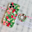 Garden Party pattern MagSafe phone grip ring with pink and white roses on a deep forest green background compatible with iPhone and Samsung