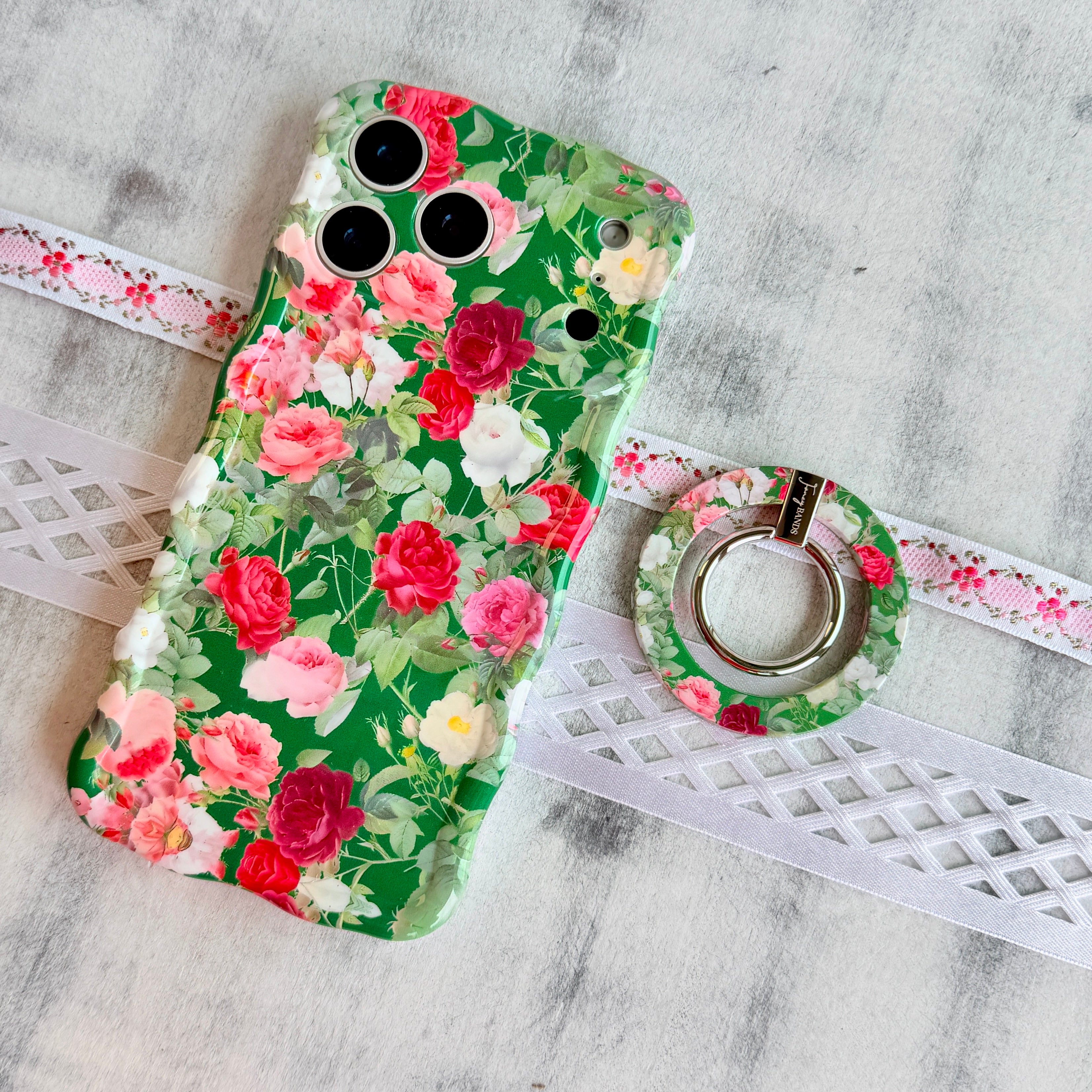 Garden Party pattern MagSafe phone grip ring with pink and white roses on a deep forest green background compatible with iPhone and Samsung