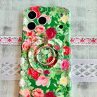 Garden Party pattern MagSafe phone grip ring with pink and white roses on a deep forest green background compatible with iPhone and Samsung