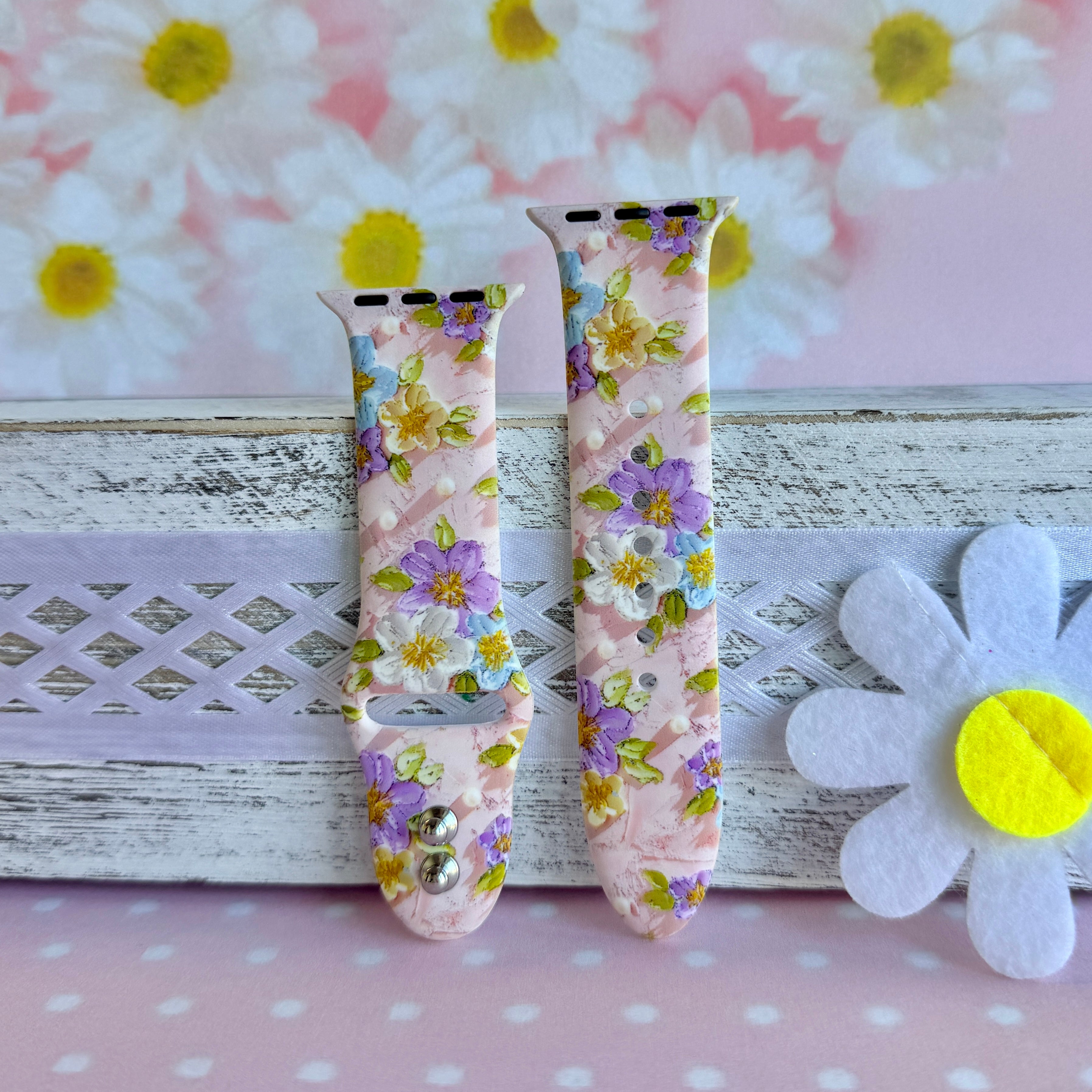 Blushing Bouquet Apple Watch band with watercolor flowers in purple, blue, yellow, and white on soft pink background
