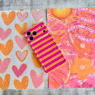 Wavy iPhone case featuring alternating horizontal stripes of hot pink and bright orange with a glossy finish.