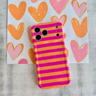 Wavy iPhone case featuring alternating horizontal stripes of hot pink and bright orange with a glossy finish.
