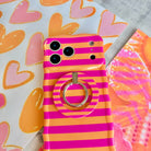 Candy Citrus Stripes Hold It Fancy MagSafe grip ring attached to the matching pink and orange striped iPhone case