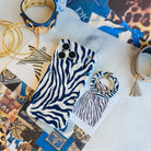 Zebra, Obviously navy zebra print MagSafe grip ring shown beside the matching zebra iPhone case on an animal-print fashion flat lay with a tassel keyring and gold hoops.