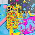Oops It's the 90's retro pop art MagSafe phone grip ring with yellow background and colorful drawings of cassette players puzzle cubes and brick phones compatible with iPhone and Samsung