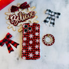 Buffalo Plaid Snowflake MagSafe grip ring beside the matching iPhone case, with a Believe sign and buffalo check bows