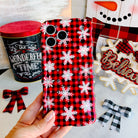 Hand holding the Buffalo Plaid Snowflake Wavy Luxe MagSafe iPhone case, red and black buffalo check scattered with white snowflakes