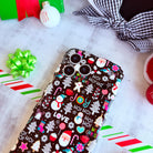 Glossy black Christmas iPhone case with festive holiday icons and wavy edges