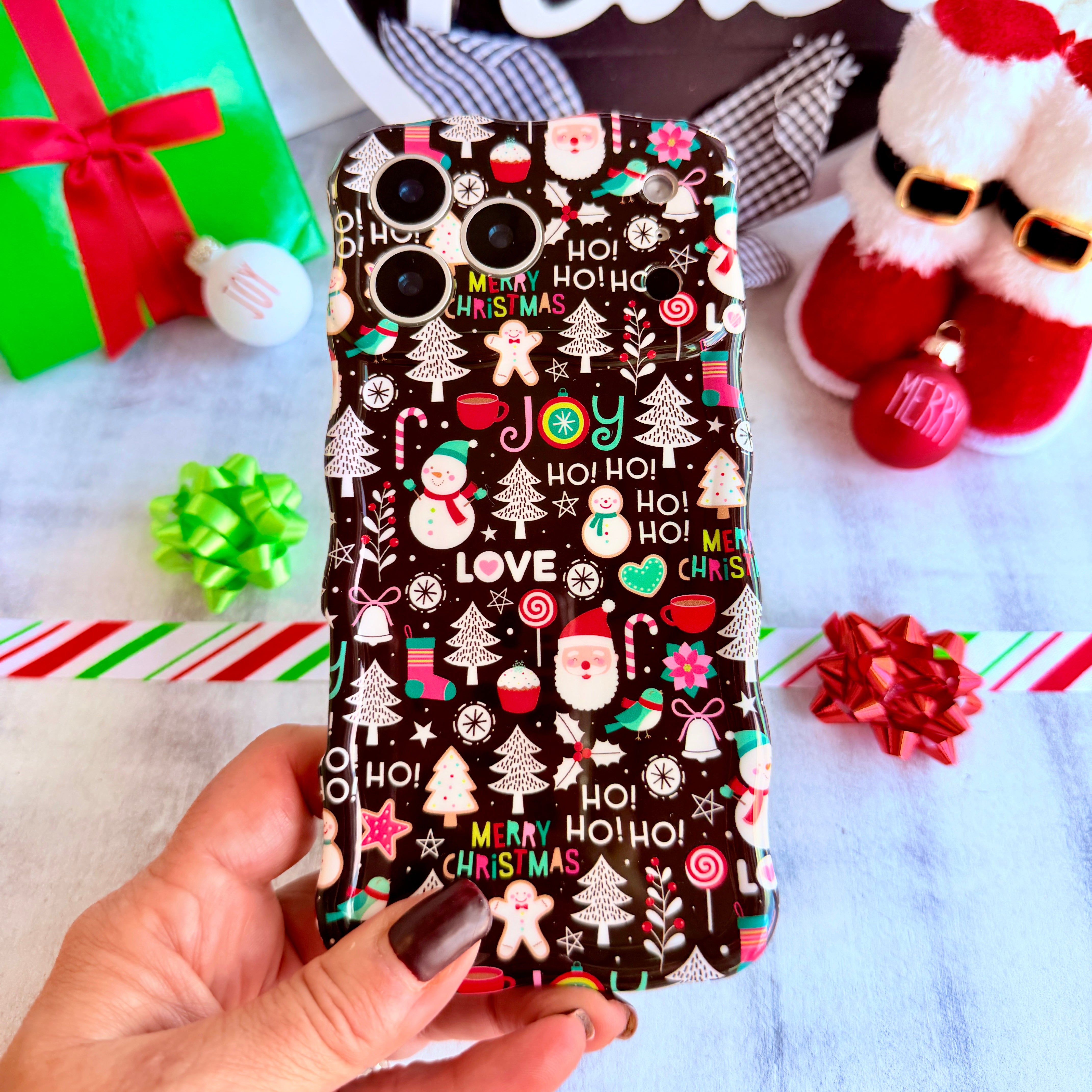 Jolly Wristmas Wavy Luxe MagSafe iPhone case — black with Santa, snowmen, candy canes