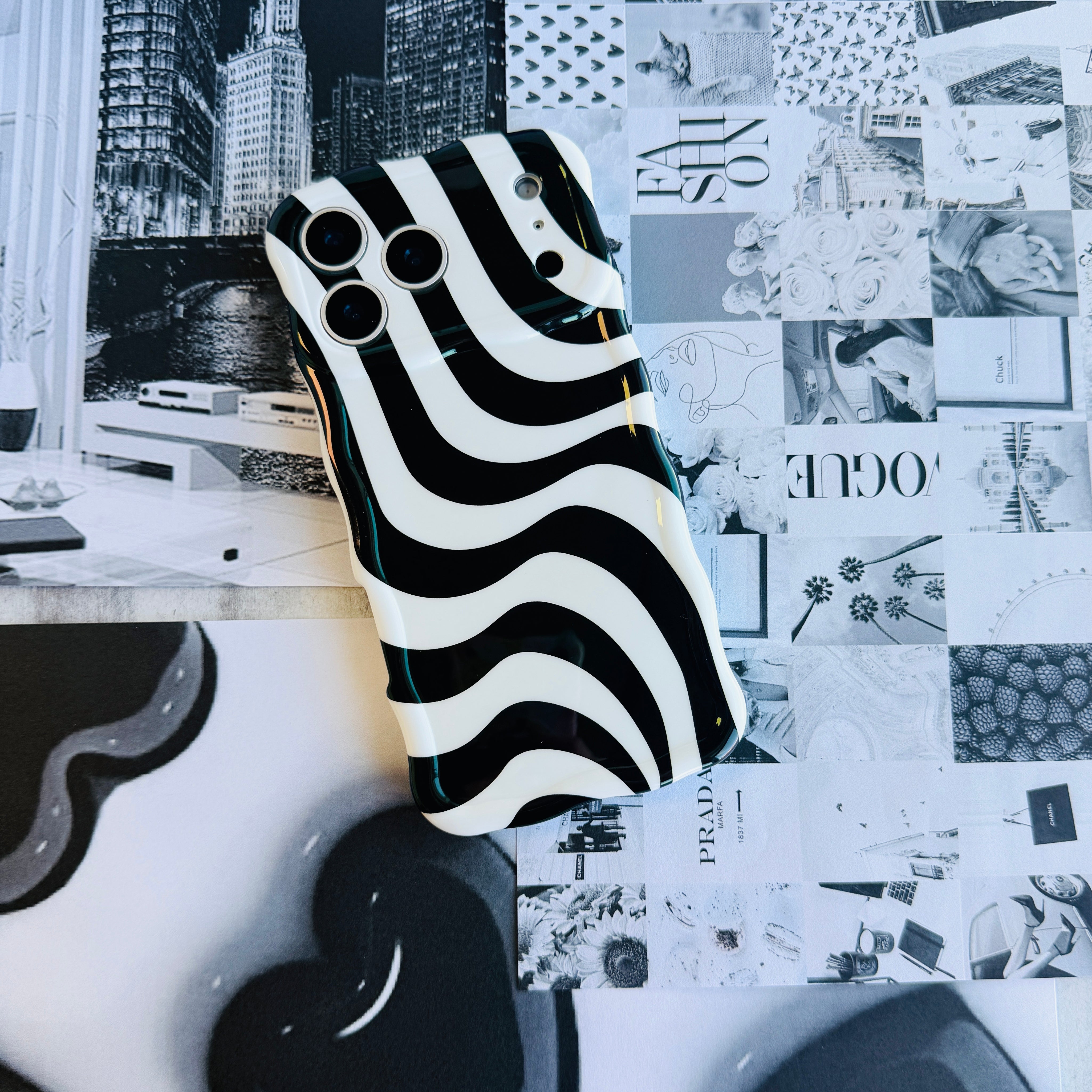 Wavy iPhone case featuring a bold black and white swirly striped pattern with a high-gloss finish.