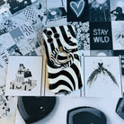 Wavy iPhone case featuring a bold black and white swirly striped pattern with a high-gloss finish.