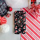 Snowman Hold It Fancy MagSafe grip ring attached to the matching snowman iPhone case, on candy cane stripes with a Santa hat and ornaments