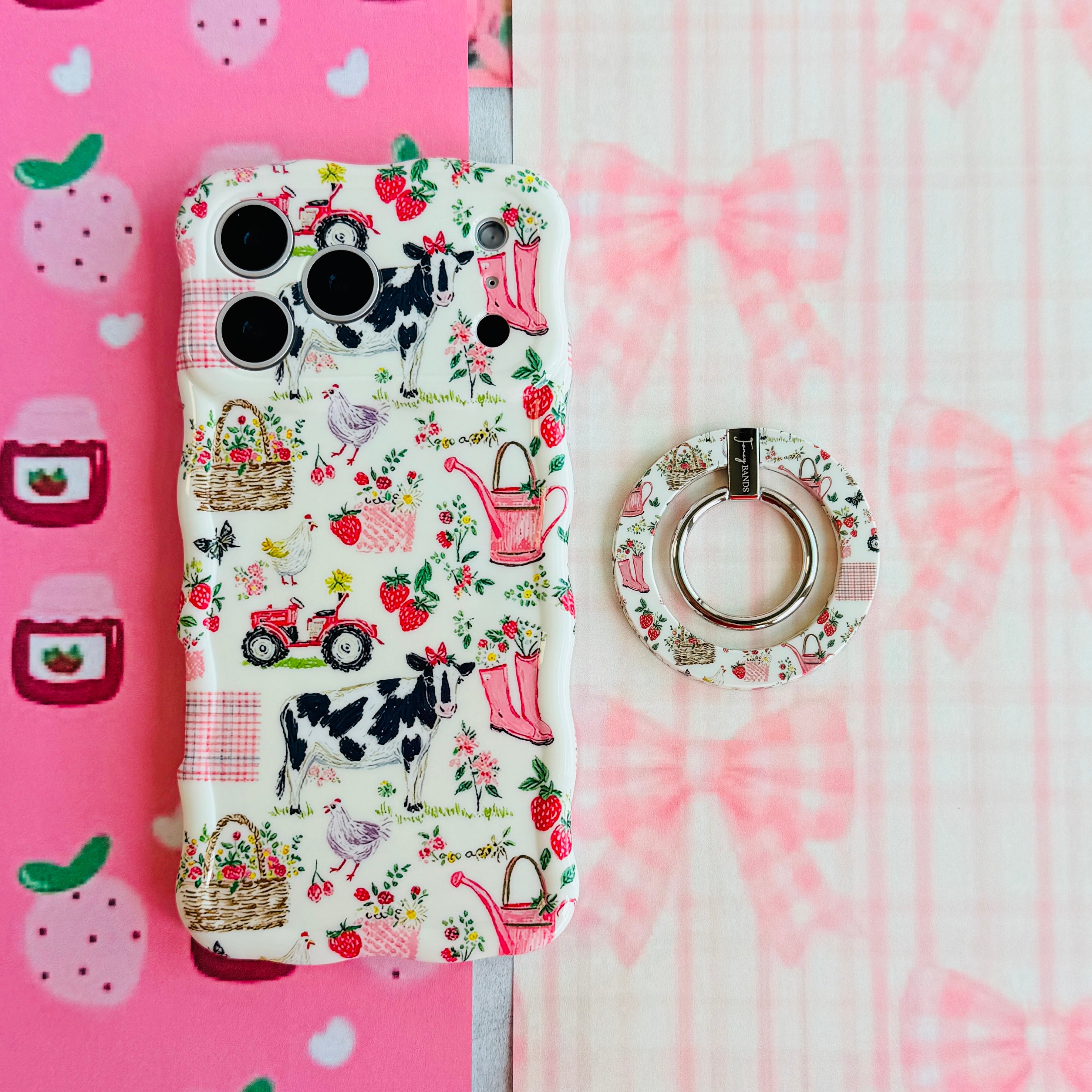 Farm Girl Cutie cottagecore MagSafe phone grip ring with pink watering cans, strawberries, rain boots, and gingham patterns on an off-white background compatible with iPhone and Samsung