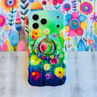 Wavy iPhone case featuring vibrant watercolor flowers in pink, red, yellow, and orange on a green and blue gradient background.