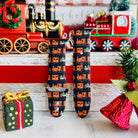 Apple Watch with Jolly Trolly train pattern band next to holiday decorations