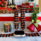 Smartwatch with a festive band on a decorative background with Christmas-themed items.