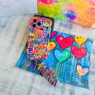 Love Riot scrunchie phone wrist strap clipped to the matching Love Riot Wavy Luxe iPhone case