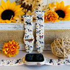 Two watch straps with horse designs on a surface with sunflowers and decorative elements.