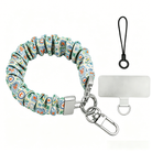 A Coastal Catch scrunchie phone wrist strap featuring a blue tile, orange lobster, and yellow lemon pattern attached to a matching Wavy Luxe phone case on a blue and white striped background.