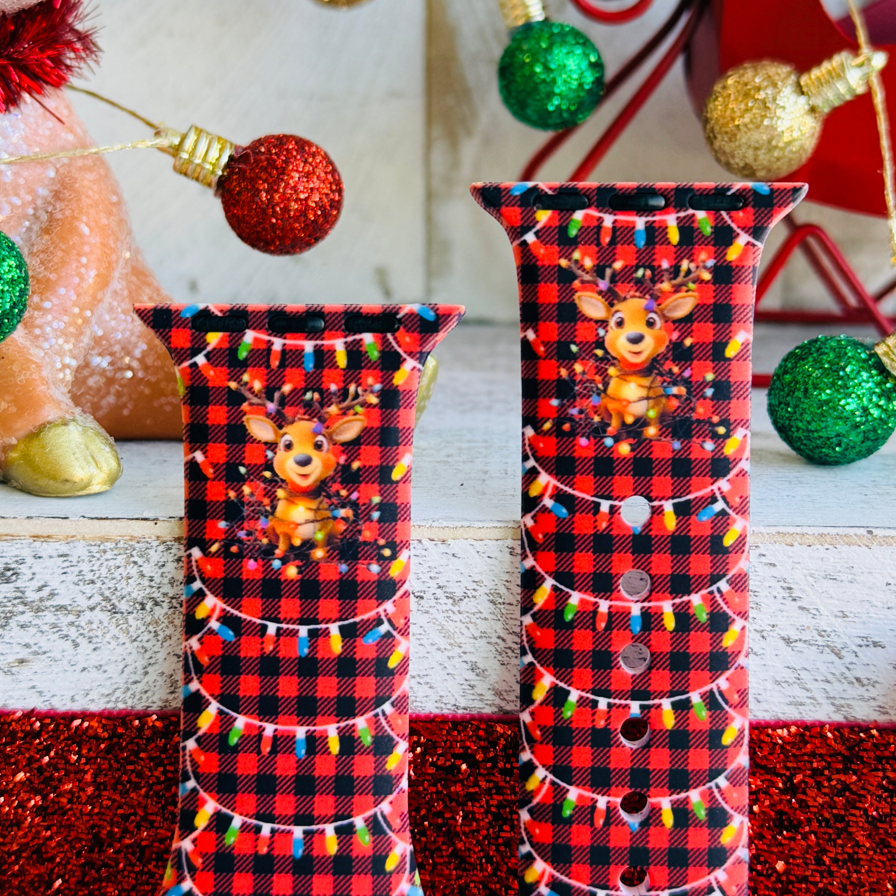 Close-up of Deerlightful reindeer print with festive lights on red and black buffalo check Apple Watch silicone band
