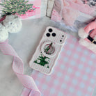 Pretty in PinkMas iPhone case with the matching pink striped MagSafe grip ring snapped on, with pink gingham ribbon and white pom-poms