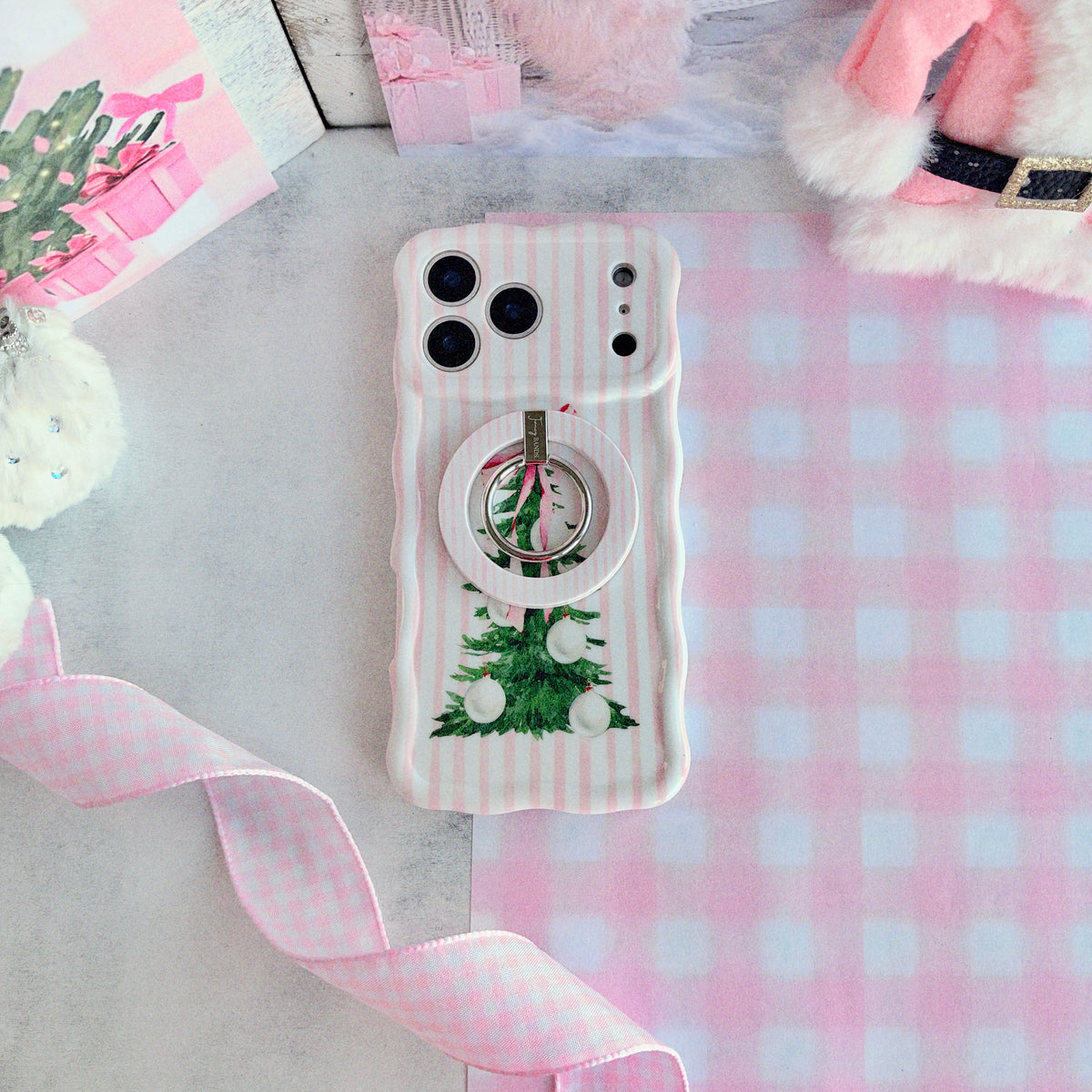 Pretty in PinkMas pink striped MagSafe grip ring snapped onto the matching iPhone case on pink gingham paper