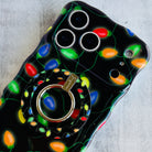 Phone case with colorful Christmas lights design on a gray surface