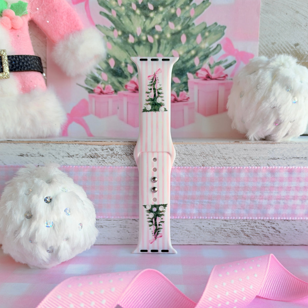 Pretty in PinkMas Apple Watch band assembled and standing upright, pink and white stripes with two bow-tied trees