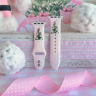 Pretty in PinkMas Apple Watch band straps with pink polka-dot ribbon and white pom-poms on a whitewashed shelf